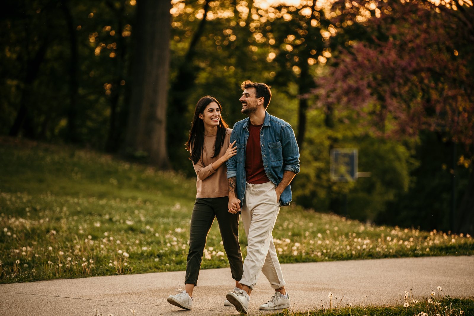 Couple walking through a sunlit park near Parkside Living in Kemptville